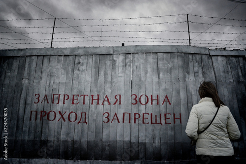 high fence with barbed wire photo