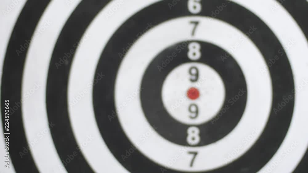 Playing darts on black-white dartboard with five darts Playing darts on black-white dartboard with five darts