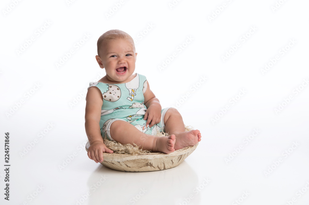 Laughing Baby Boy Sitting in a Rustic Bowl Laughing Baby Boy Sitting in a Rustic Bowl