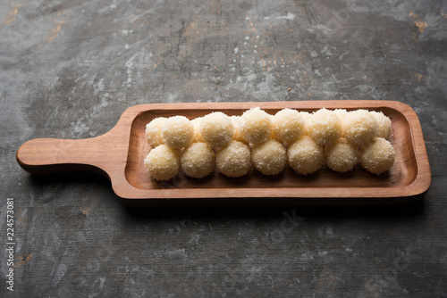 Coconut Sweet Laddoo OR Nariyal Ladduis a Popular Festival food from India. Served over moody background, selective focus photo