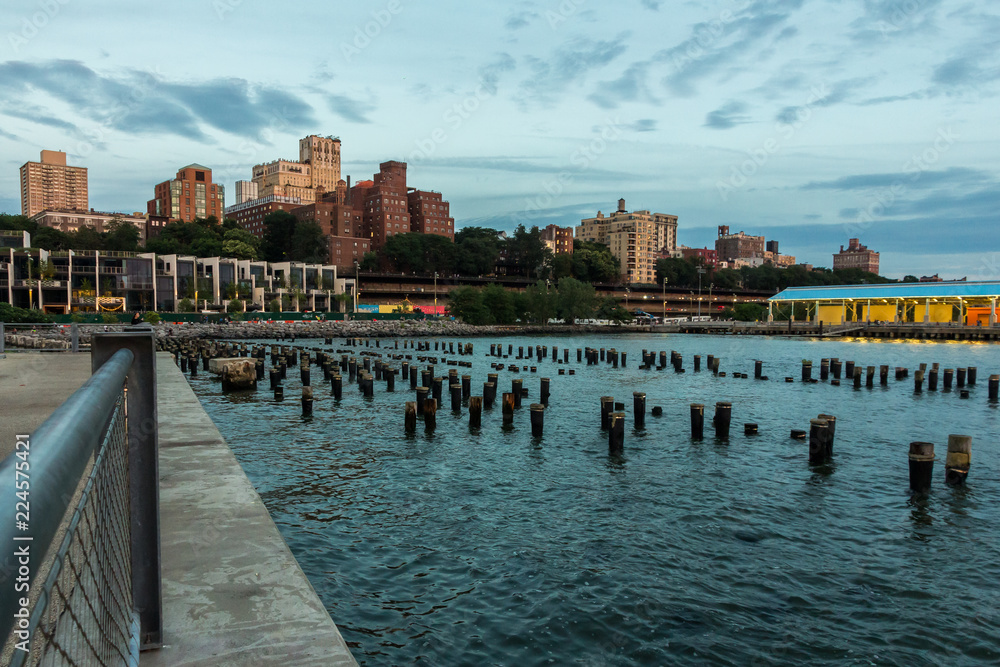 Brooklyn waterfront from Pier 1, with some submerged poles in the foreground (New York, USA)