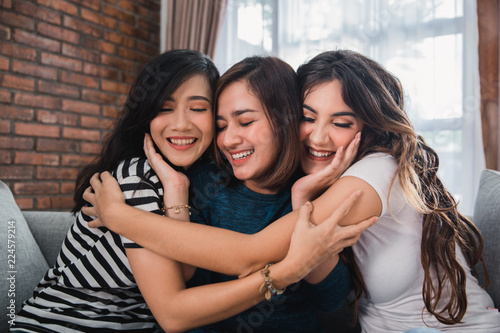 three friends embracing each other 