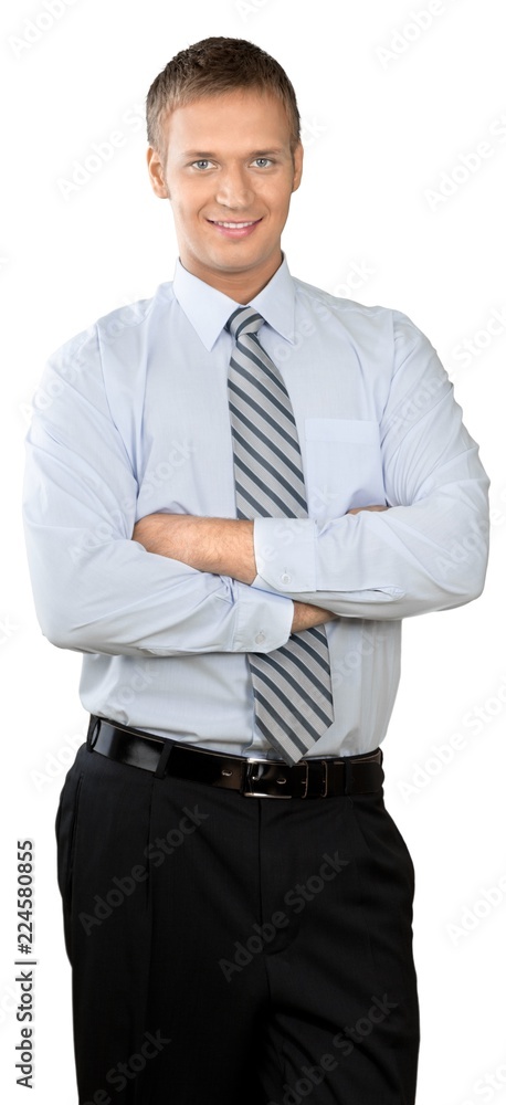 Professional looking man with his arms crossed wearing a button Professional looking man with his arms crossed wearing a button