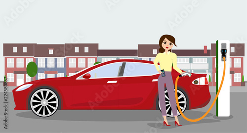 Woman charges an electric car at a charging station for electric vehicles.