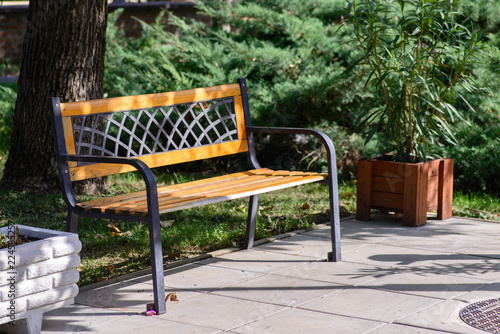 A lattice-patterned bench in a park.