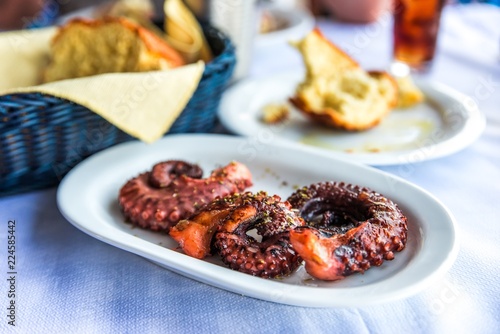 Grilled octopus tentacle, bread,.