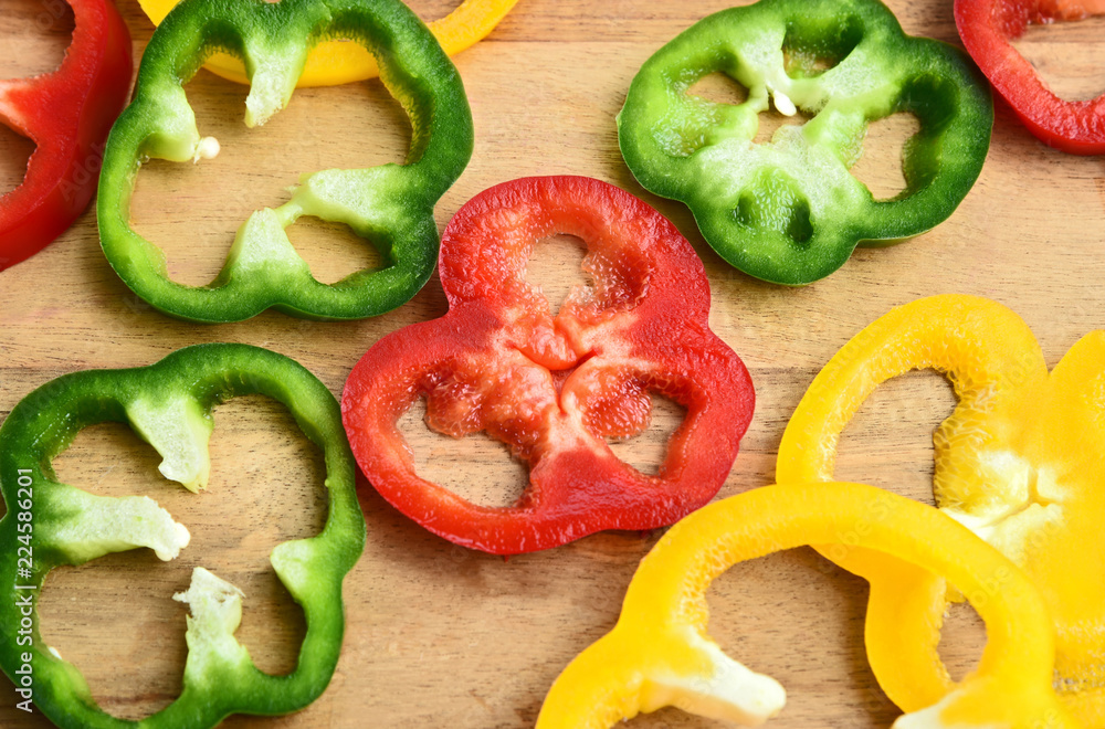 Mixed and colorful of Bell pepper sliced on wooden board. Mixed and colorful of Bell pepper sliced on wooden board.