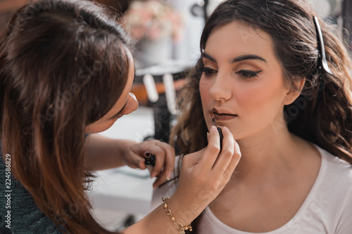 woman having make up applying by artist 