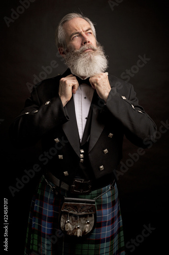 mature male model wearing kilt with grey hairstyle and beard