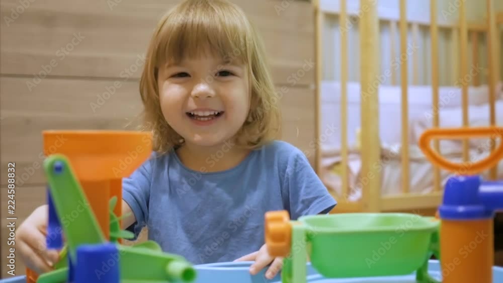 Little Child plays with a multi-colored toy. A preschool boy play in a developing toy at home in the playroom. Little Child plays with a multi-colored toy. A preschool boy play in a developing toy at home in the playroom.