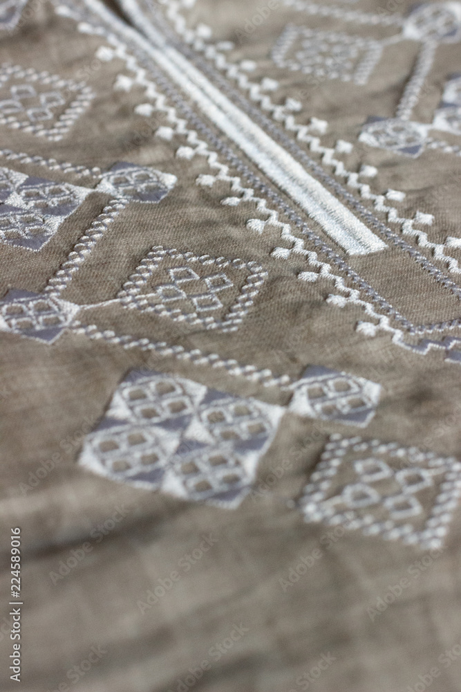 Obraz premium Embroidered linen shirt, white ornament, close