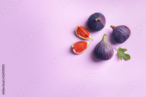 Fresh ripe figs on light background, top view. Space for text photo