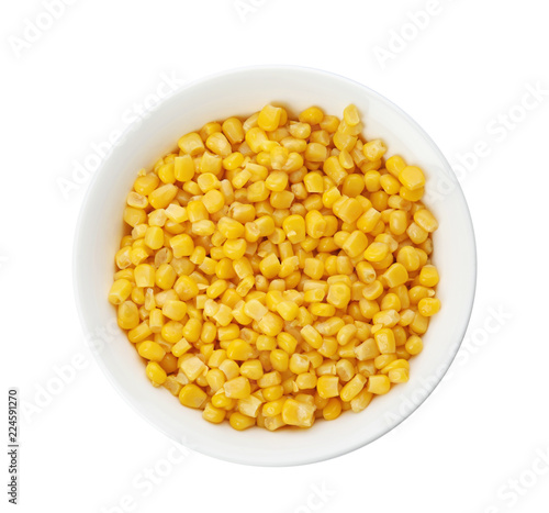 Bowl with corn kernels on white background, top view