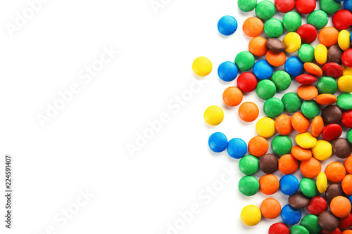 Tasty colorful candies on white background, top view
