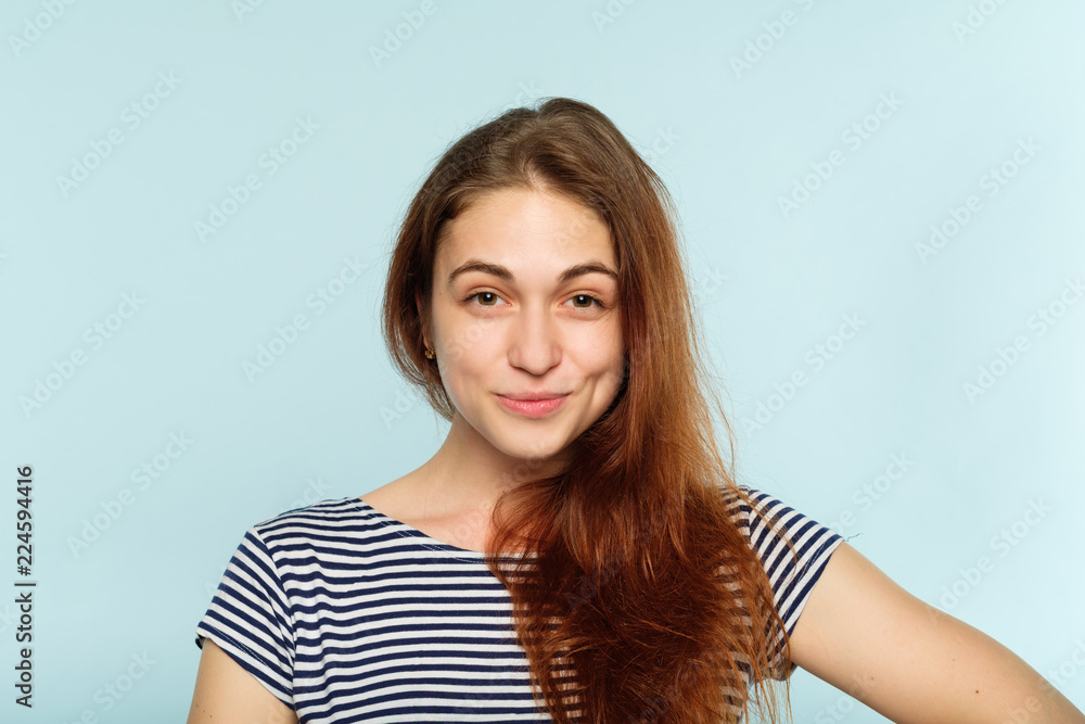 facial expression. emotional portrait. happy smiling joyful jolly woman. young beautiful brown haired girl on blue background. facial expression. emotional portrait. happy smiling joyful jolly woman. young beautiful brown haired girl on blue background.