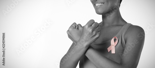 Smiling woman crossing arms for breast cancer awareness