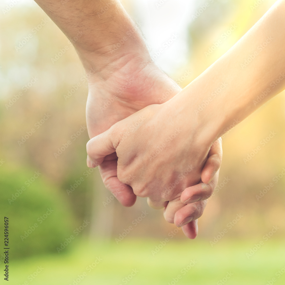 Two hands together, a man and a woman holding hands. Husband and wife together. Support and understanding Two hands together, a man and a woman holding hands. Husband and wife together. Support and understanding