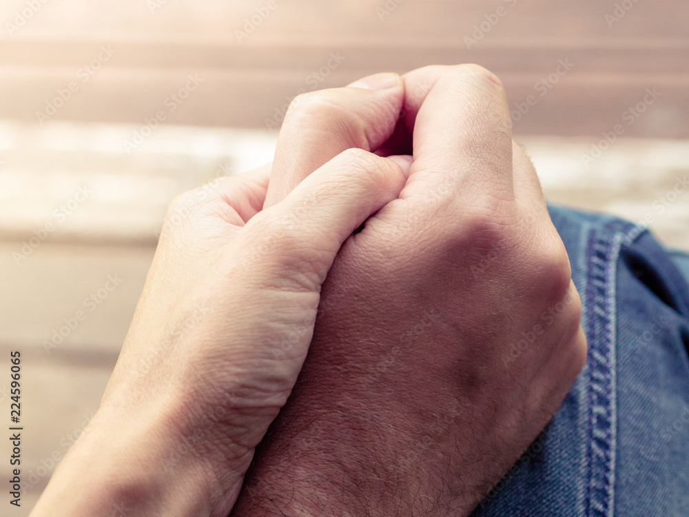 Fototapeta premium Two hands together, a man and a woman holding hands. Husband and wife together. Support and understanding