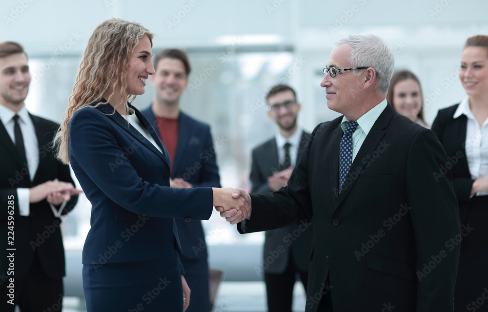 handshake serious businessman and business woman handshake serious businessman and business woman