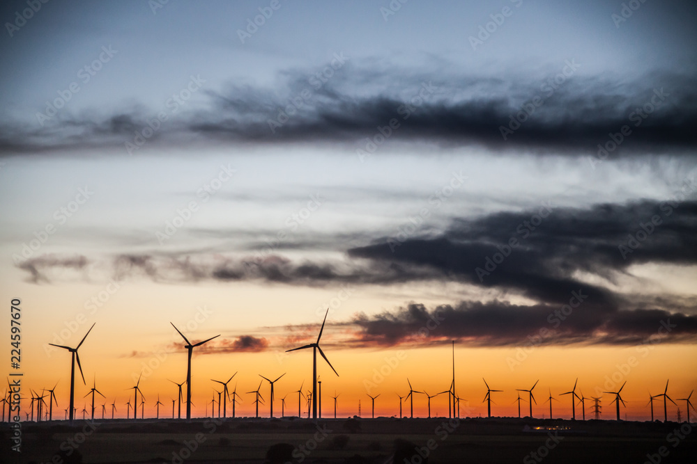 Sunset landscape at wind generators field