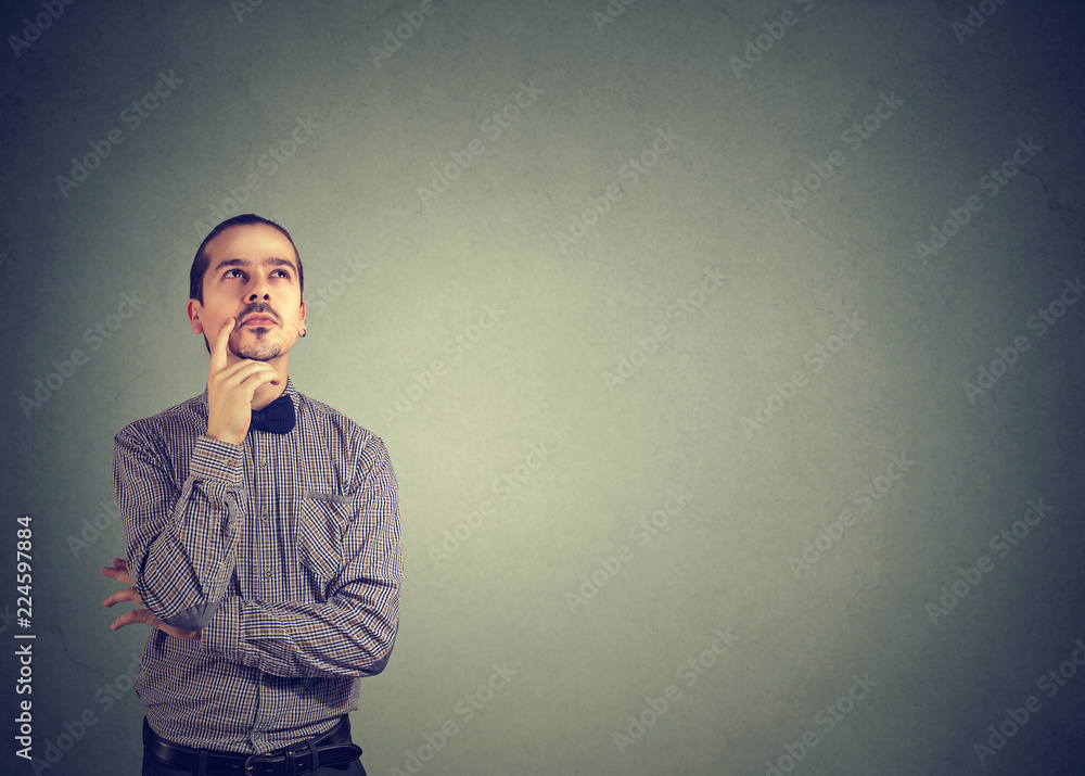 Pensive young man thinking looking up Pensive young man thinking looking up