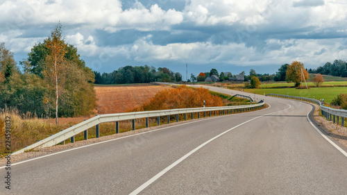 Autumn landscape with asphalt road and forest. photo