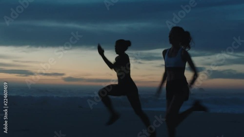 silhouette of women running sprinting on beach athletes training intense cardio enjoying competitive workout challenge early morning run photo