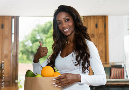 Sporty african american woman with fresh and healthy fruits