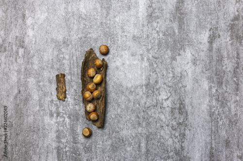 Composition of hazelnuts at gray background. Nuts on tray.