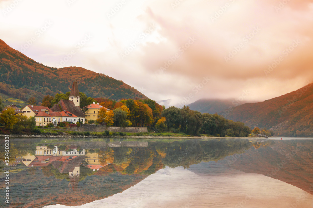 Fototapeta premium Quaint small town on the shore of the Danube River in Austria in the Fall