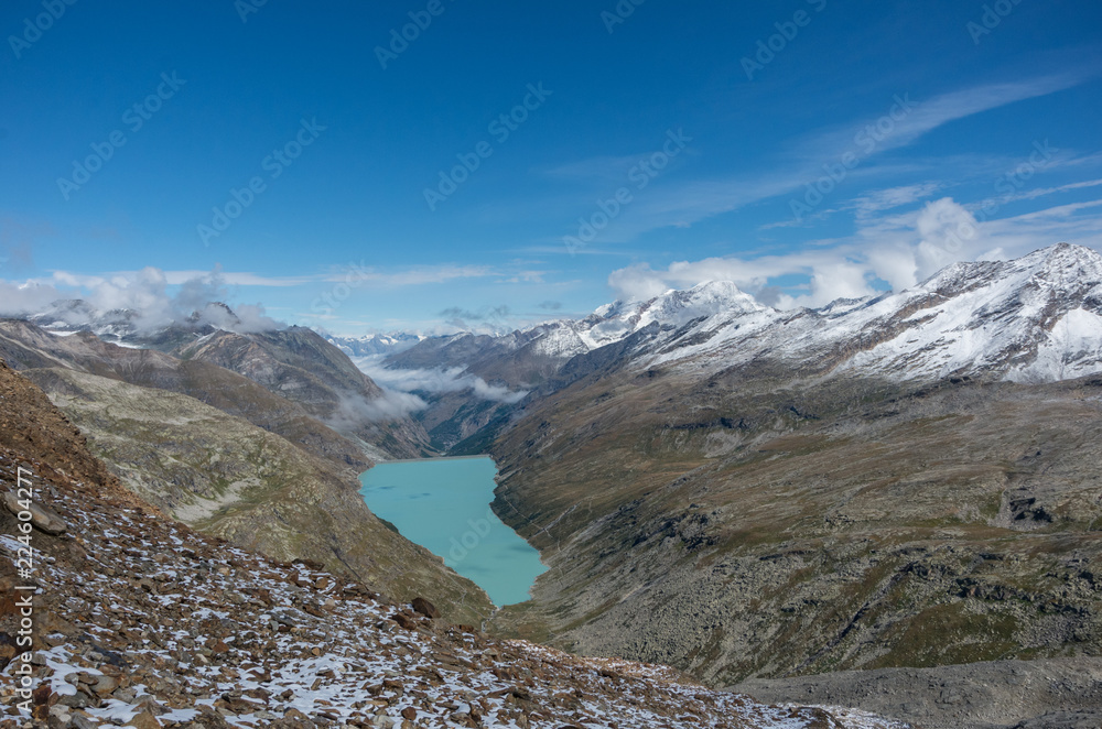 View to Stausee lake near Saas Fee in the southern Swiss Alps from Monte Moro pass, Italy