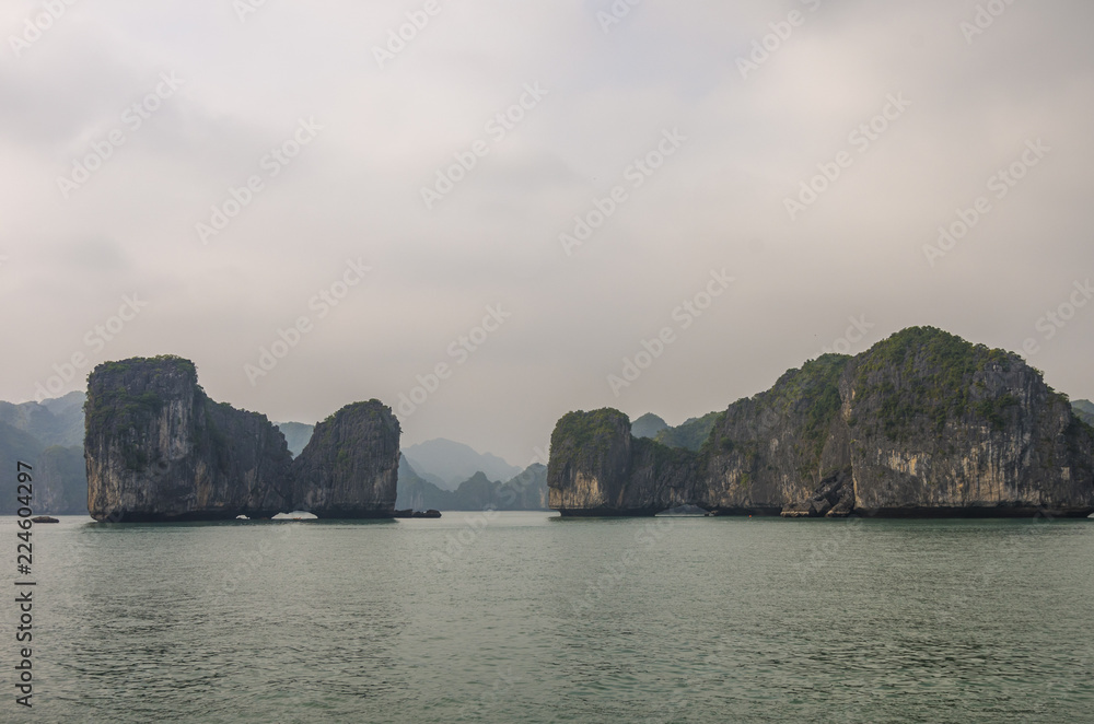 Beautiful limestone mountain scenery at Ha Long Bay, North Vietnam. Foggy weather in winter day.