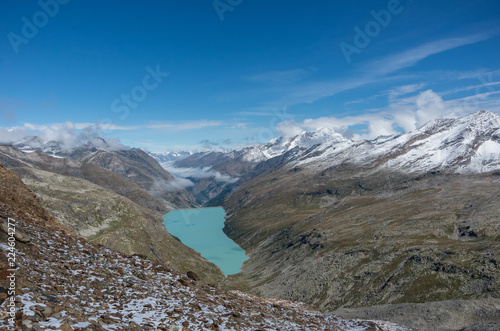 View to Stausee lake near Saas Fee in the southern Swiss Alps from Monte Moro pass, Italy © smoke666