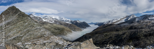 Monte Moro pass from Switzerland into Italy and the Stausee lake near Saas Fee in the southern Swiss Alps. Panorama