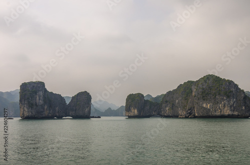 Beautiful limestone mountain scenery at Ha Long Bay  North Vietnam. Foggy weather in winter day.