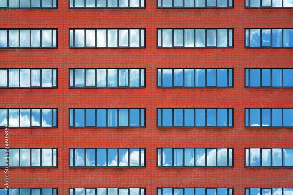 Old red brick wall with windows. Facade of office building with windows. Facade of an old red brick wall with windows. Old red brick wall with windows. Facade of office building with windows. Facade of an old red brick wall with windows.
