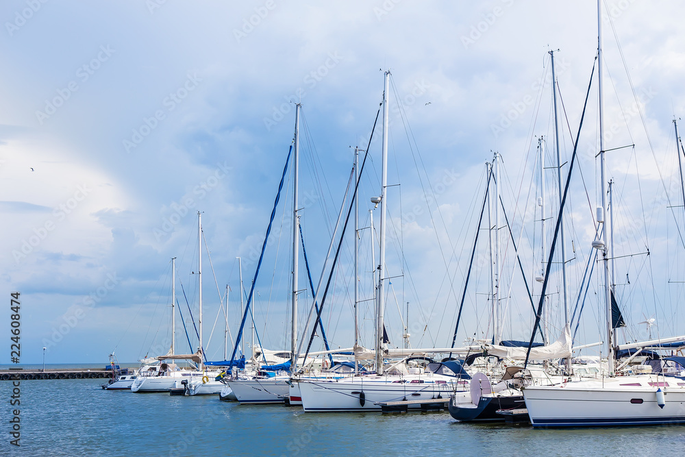 sailboats are moored on a pier