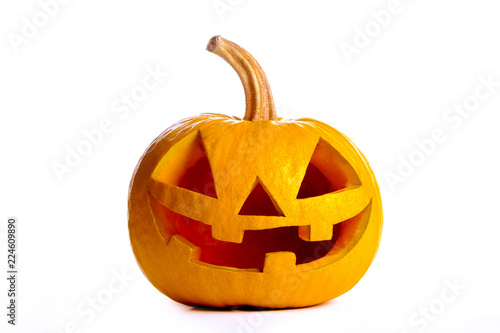 Fotografie Orange pumpkin carved into creepy and funny Jack o Lantern isolated on white background