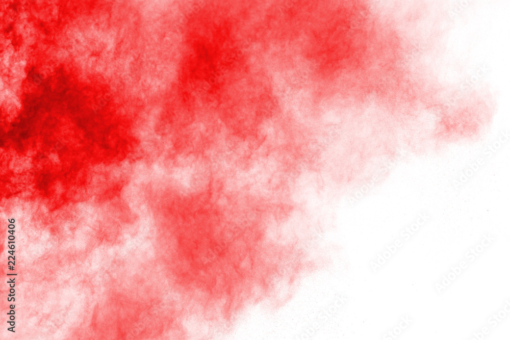 Freeze motion of red powder exploding, isolated on white background. Abstract design of red dust cloud. Particles explosion screen saver, wallpaper