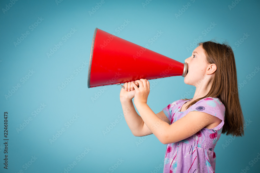 Girl Announcing with Megaphone, Isolated on Teal Girl Announcing with Megaphone, Isolated on Teal