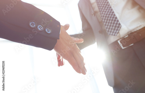 Two business men going to make handshake