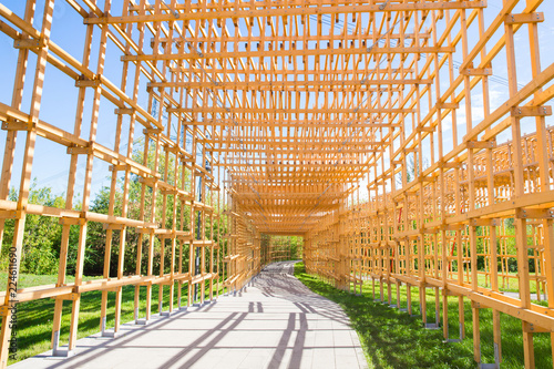 Yellow wooden arch on the road in park