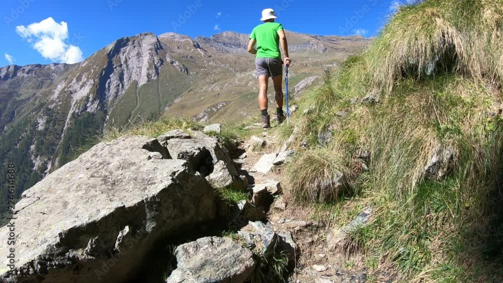 man trekking in the Alps in a beautiful sunny day
man trekking in the Alps in a beautiful sunny day