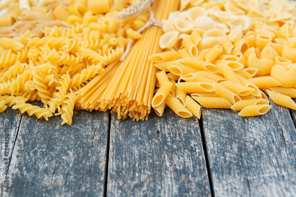 composition of raw pasta different shapes, frame of raw pasta. room for text composition of raw pasta different shapes, frame of raw pasta. room for text
