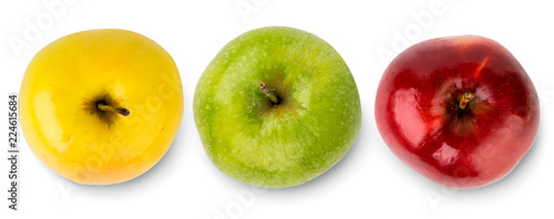 Three apples of different colors yellow, green and red on a white. The view from the top.