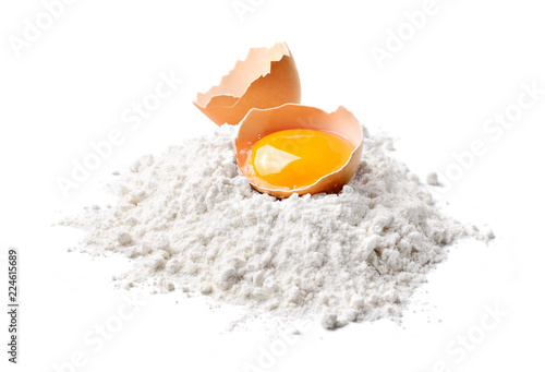 Chicken egg and flour isolated on white background