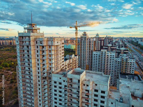 Construction site with building cranes and other equipment, industrial built or estate development modern buildings, aerial view