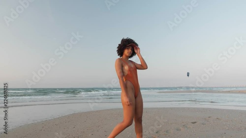 Cute model posing at the beach in a bikini set photo