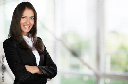 Businesswoman with crossed arms smiling at camera