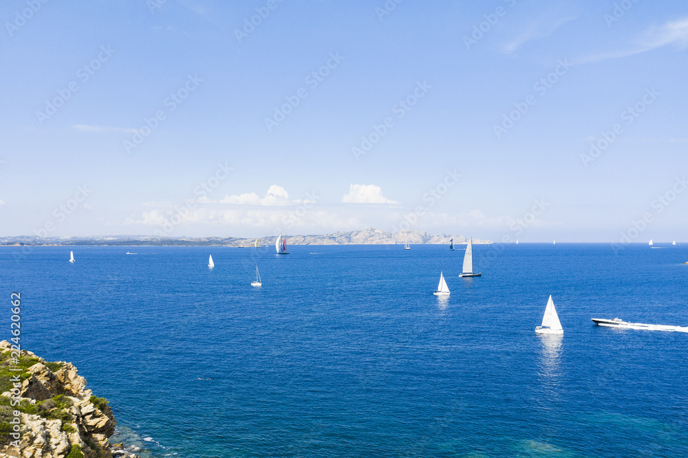 Aerial view of some beautiful sailboats sailing on a Mediterranean sea during a Regatta in Sardinia. September 2018, Italy.